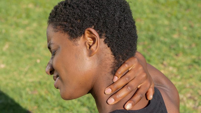 african american lady holding the back of her neck
