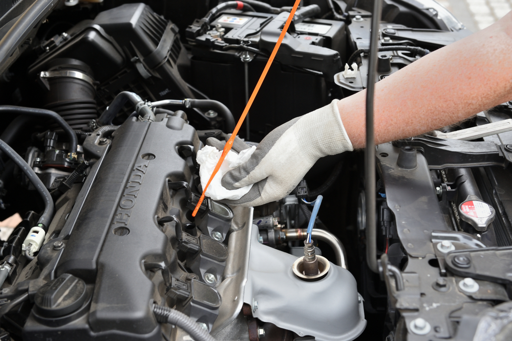 technician cleaning a honda car