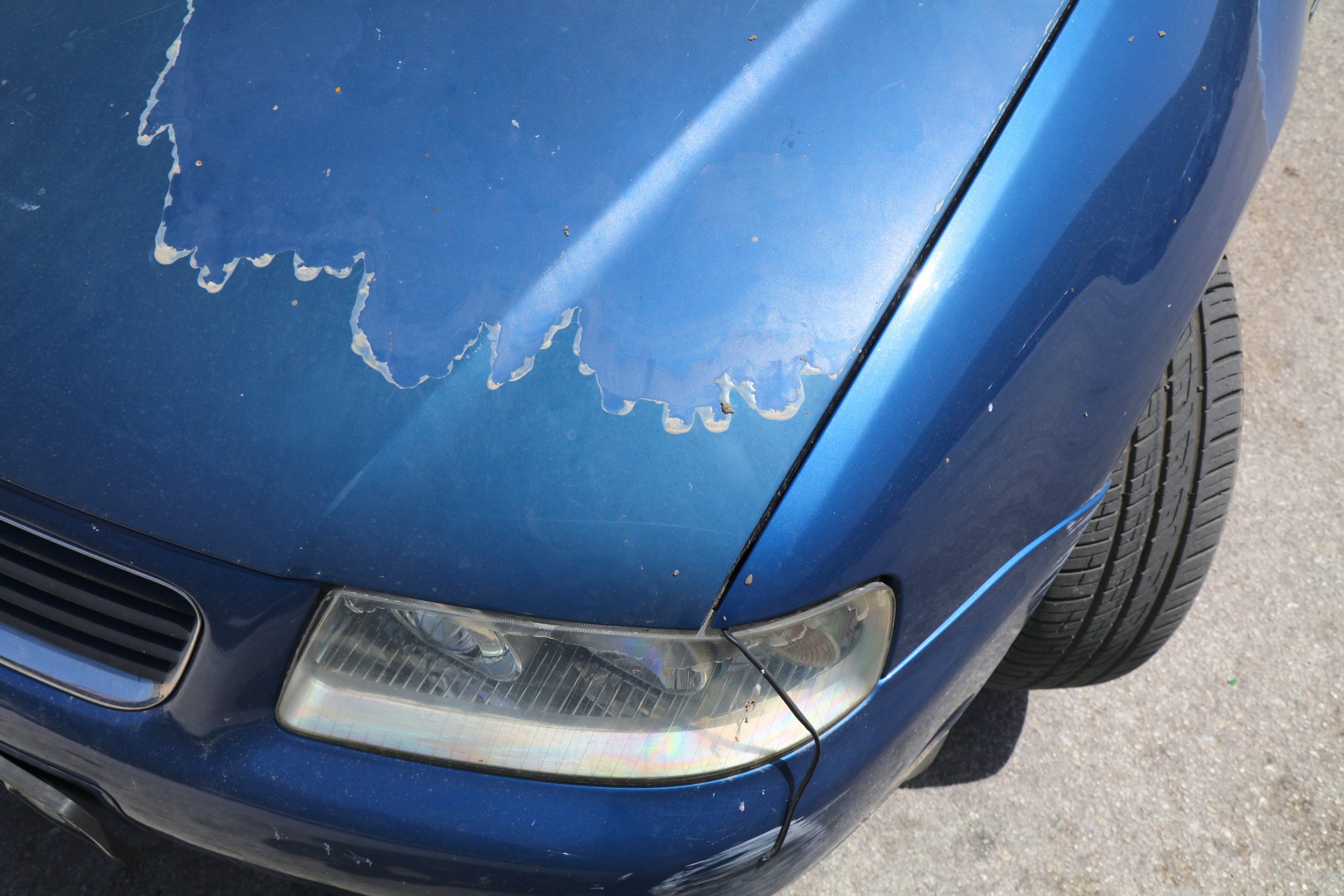 faded paint on an old blue car