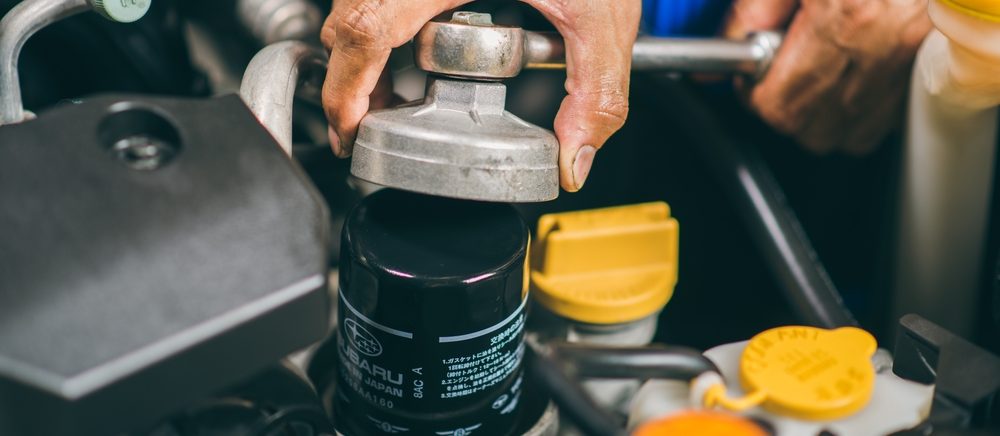 auto technician fixing subaru