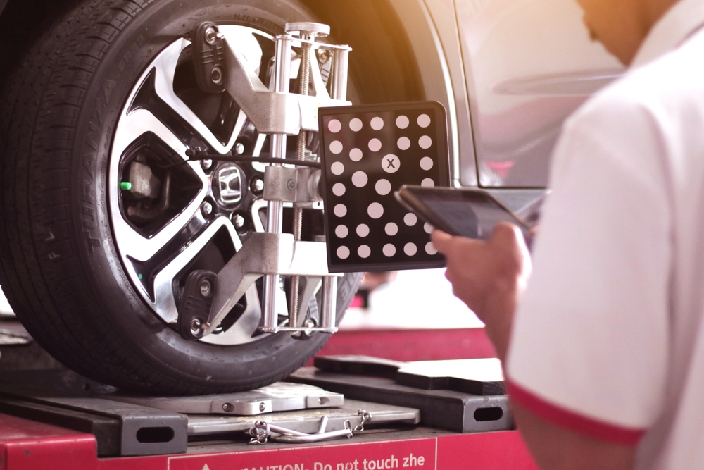 technician checking the wheel and tire pressure