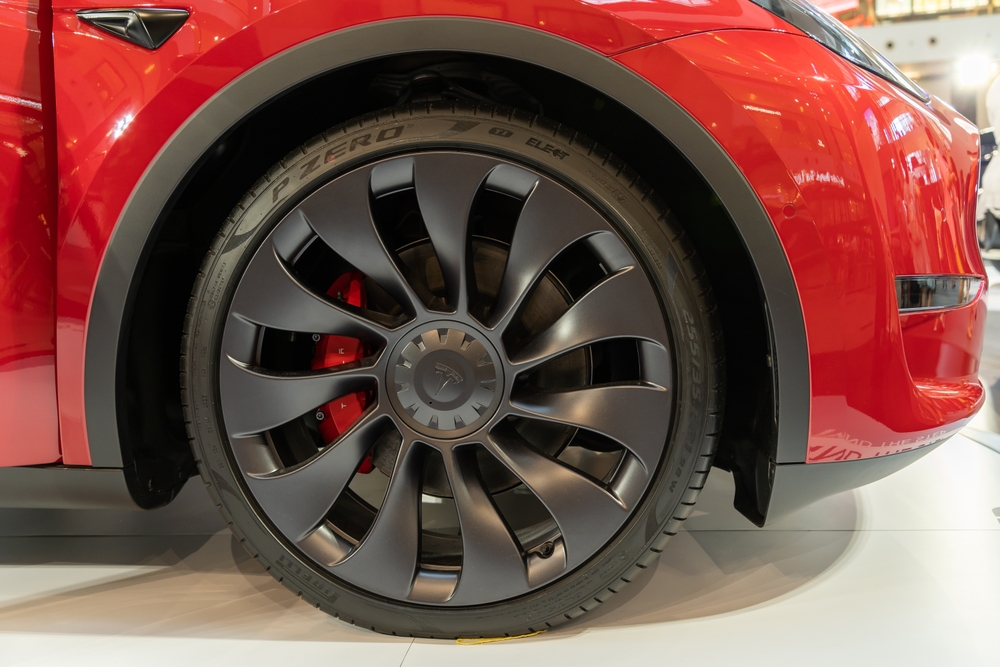 red tesla with all black wheels