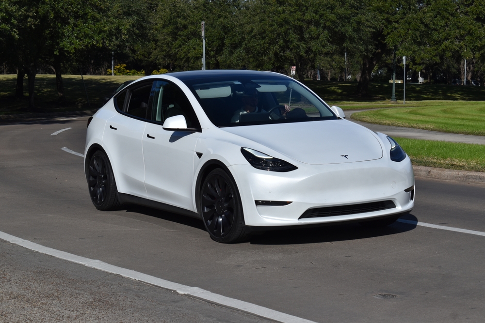 white tesla y on the road