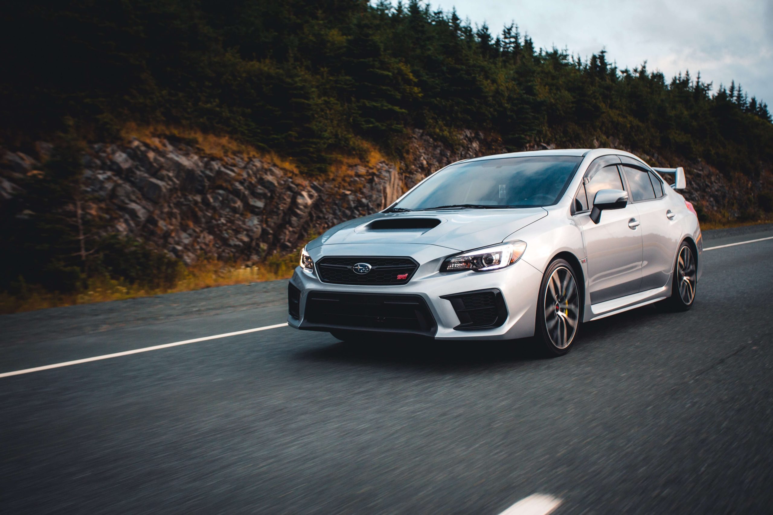  Silver Subaru Driving on a Road