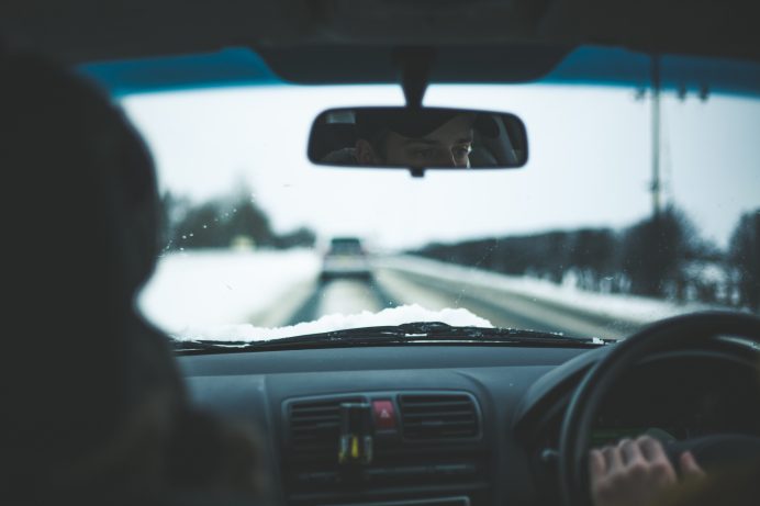inside of car view of person driving during winter