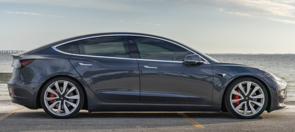 grey tesla on the road